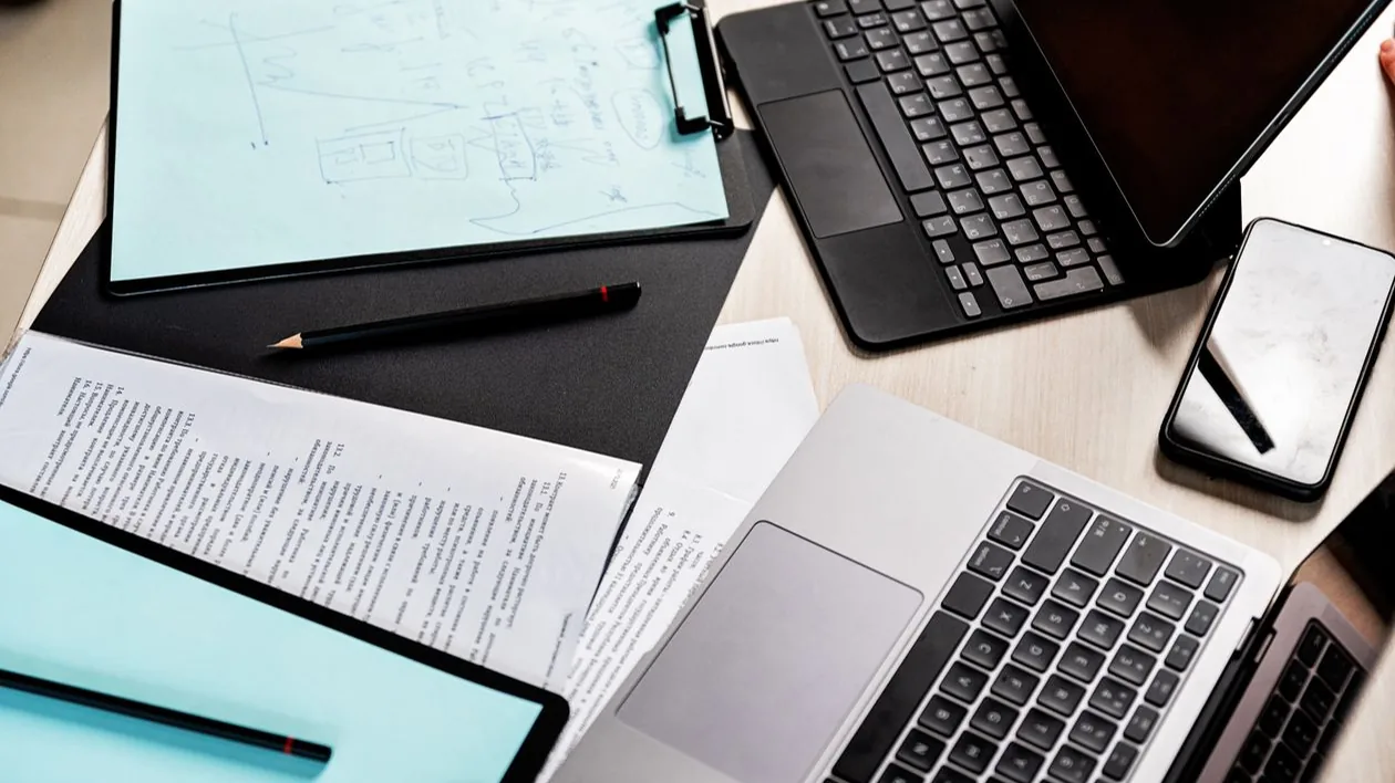 Electronic equipment and documents on a desk.