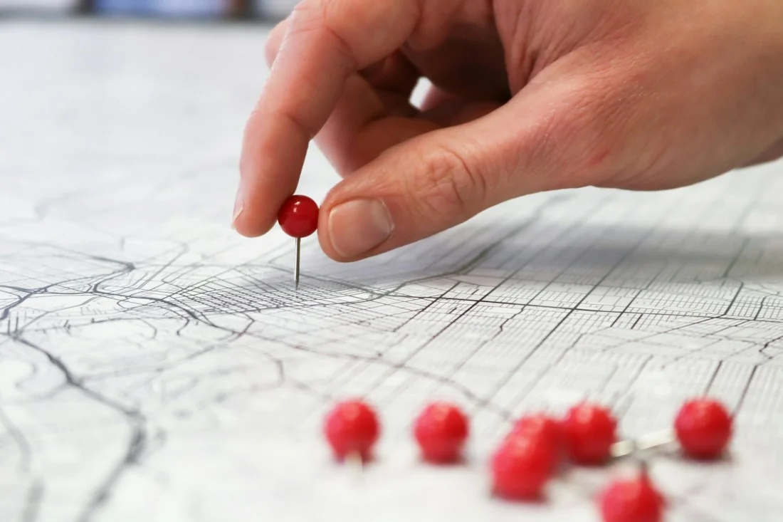 Marking a location with a red pin on a city map.