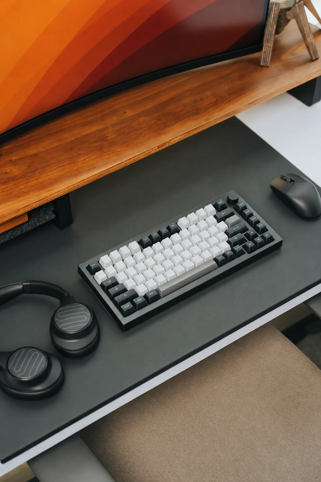Monitor, keyboard, mouse and headphones at a workstation.