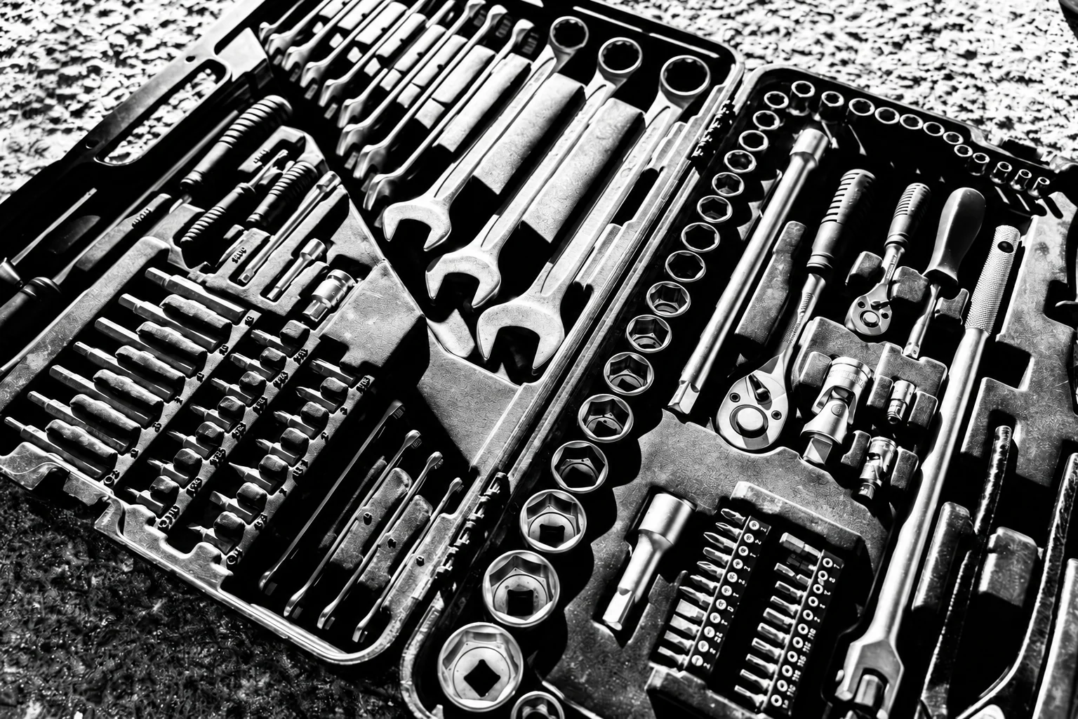 An open case containing spanners and sockets.